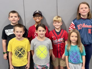 Seven Mayflower students posing together indoors